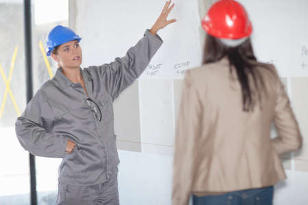 Interior designer and project manager looking at paint swatch