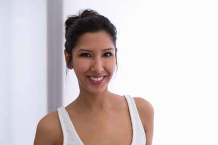 Portrait of young woman wearing white vest