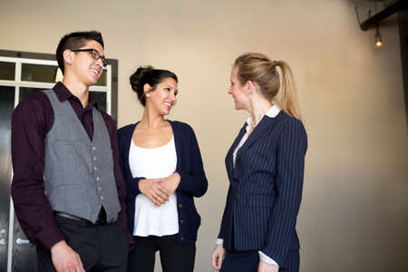 Three young businesspeople talking