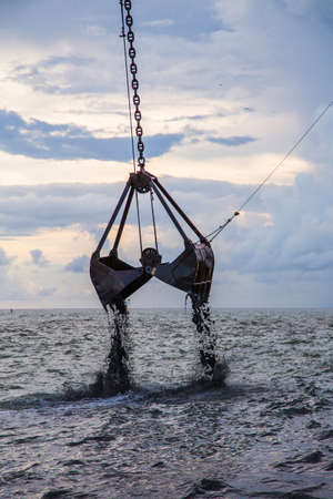 Crane operating in waterの写真素材