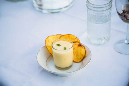 Plate of soup with potato chipsの写真素材