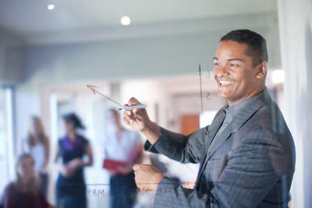 Businessman making graph on class