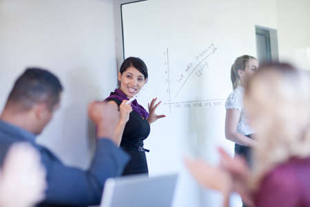 Businesswoman making graph on glassの写真素材