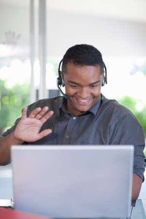 Businessman wearing headset at desk