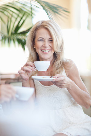 Older woman having cup of coffeeの写真素材