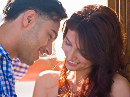 Young couple with woman smiling, close up