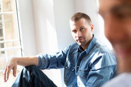 Mid adult man wearing denim shirtの写真素材