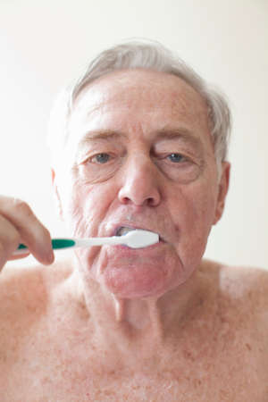 Senior man brushing teethの写真素材