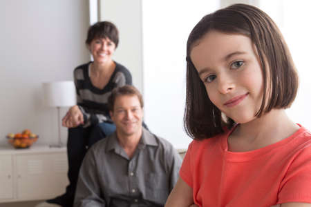 Portrait of girl with parents in backgroundの写真素材