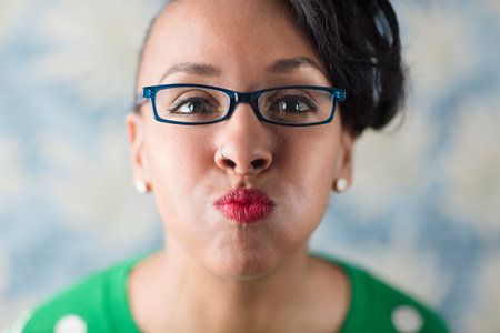 Close up portrait of woman puckering her lips