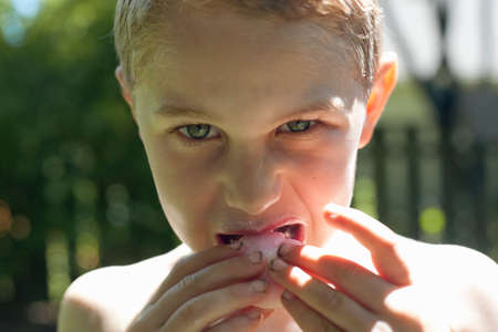 Boy biting into food