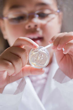 Girl holding petri dish sample