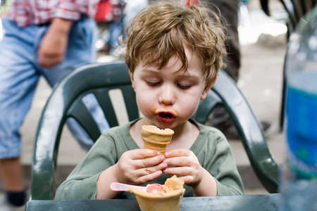 Boy looking at ice cream coneの写真素材