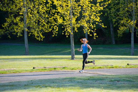 Teenage girl jogging in parkの写真素材