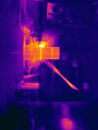Thermal image of part being turned on lathe, with heating of the cutting tool, part and shavingsの写真素材