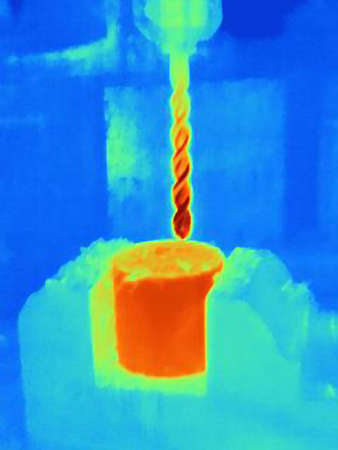 Thermal image of drilling into a component, showing the heat bulidup on the drill bit and the partの写真素材