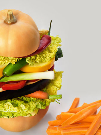 Healthy diet illustrated by a raw vegetarian burger and carrot chipsの写真素材