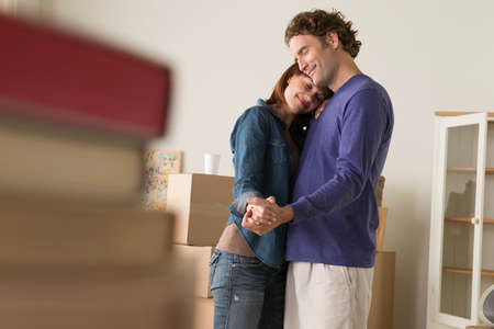 Couple having romantic dance whilst moving house