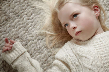 Young girl lying on rugの写真素材