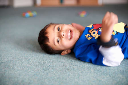 Portrait of boy lying on floor