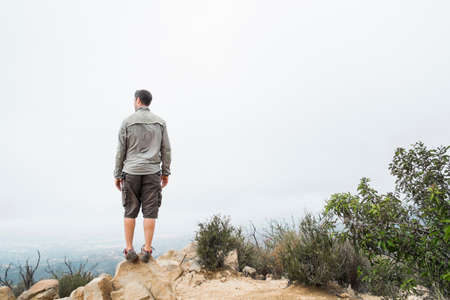 Rear view of man at top of a mountain