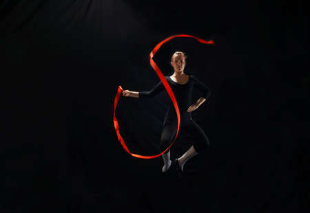 Dancer with ribbon on black backgroundの写真素材