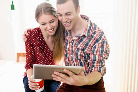 Couple on video chat using digital tabletの写真素材