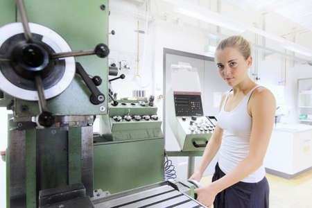 Technician working in mechanical workshop within optical laboratoryの写真素材