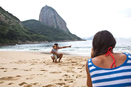Father and son on beach, Rio de Janeiro, Brazil