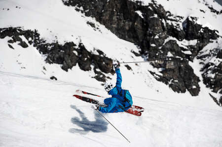 Overhead view of man skiing at speed down mountain