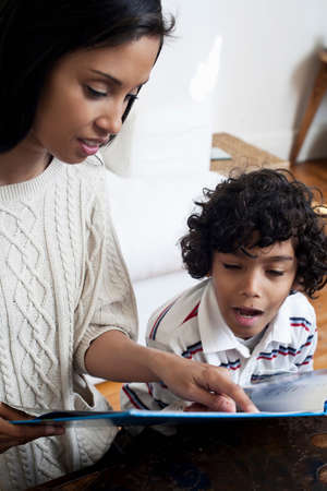 Mother and son looking at book