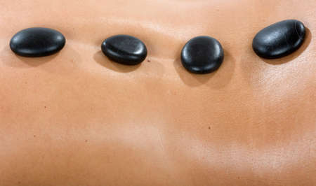 Hot stones on woman's back