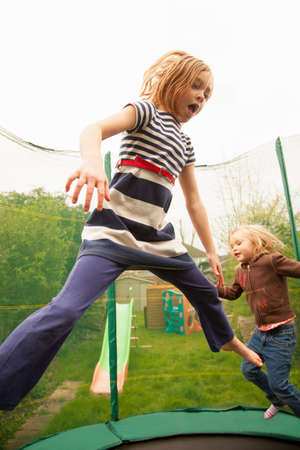 Girls jumping on trampolineの写真素材
