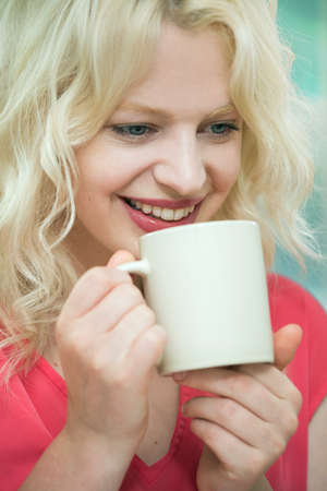 Young woman enjoying a hot drinkの写真素材
