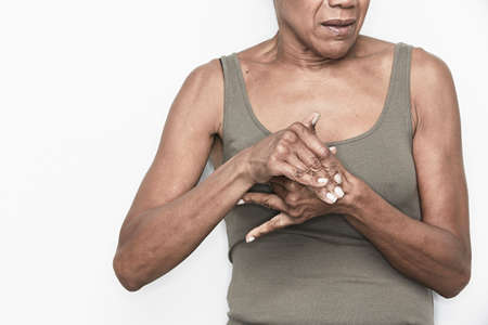 Cropped portrait of senior woman with hands claspedの写真素材
