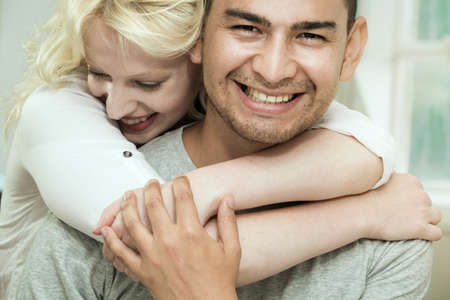 Young woman hugging boyfriend