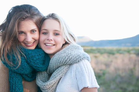 Two young women wearing knitted scarfの写真素材