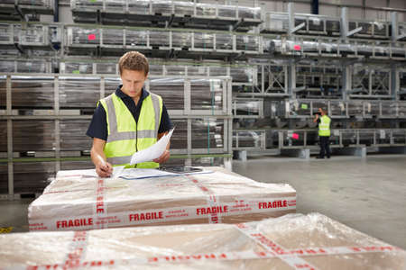 Warehouse worker checking order in engineering warehouse