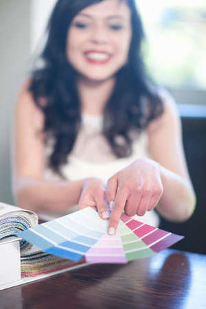Interior designer pointing at textile swatchesの写真素材