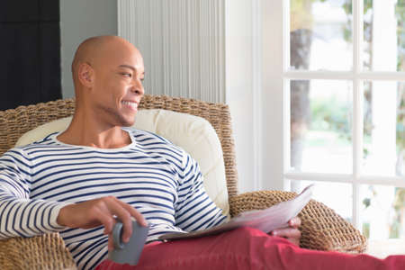 Mid adult man sitting in wicker chair