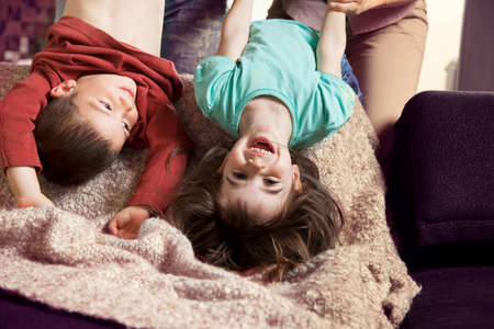 Brother and sister upside down, laughingの写真素材