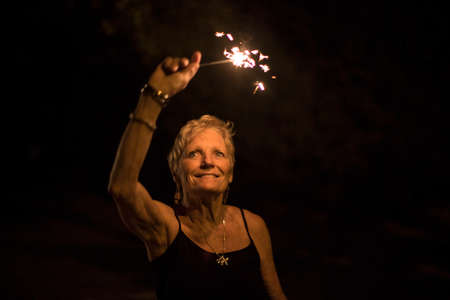 Portrait of woman holding sparkler on independence day, Destin, Florida, USA