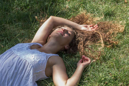 Teenage girl lying on grass, Prague, Czech Republic