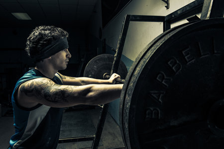 Weightlifter in dark gym