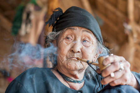 Senior woman smoking pipe, Shan State, Kengtung, Burmaの写真素材