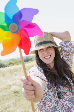 Mid adult woman holding windmillの写真素材