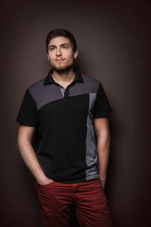 Portrait of young man wearing t shirt with hands in pocketsの写真素材