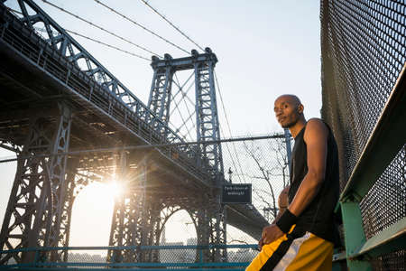 Man leaning against fenceの写真素材