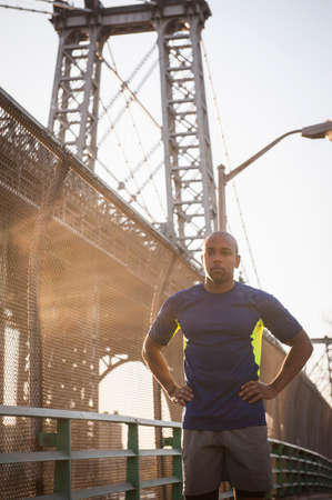 Man daydreaming below bridgeの写真素材