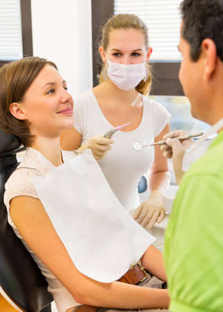 Woman having check up with dentist and dental nurseの写真素材